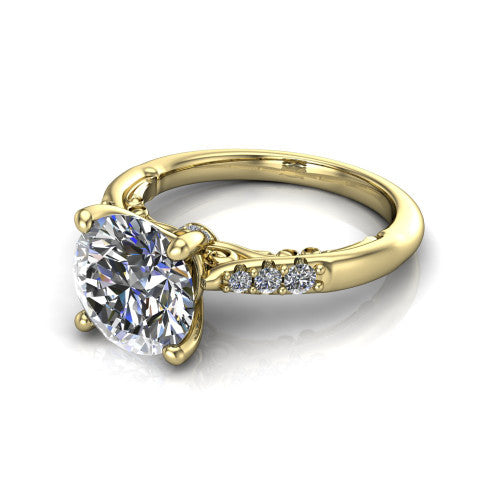 Jimena round solitaire engagement ring in 18K Yellow Gold, three-quarter perspective showing the round center raised on claw prongs above pav&eacute; shoulders