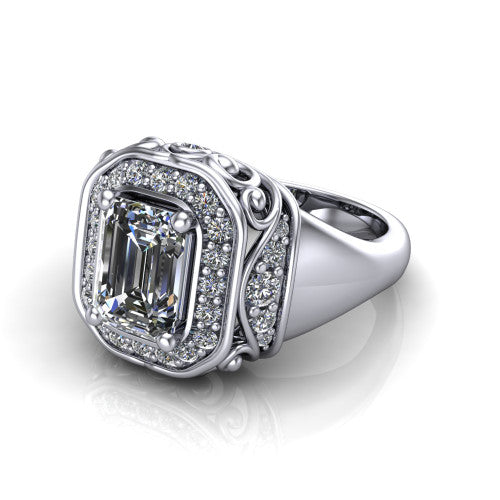 Cassidy emerald vintage halo engagement ring in Platinum, three-quarter perspective showing the emerald center in a double pav&eacute; halo with filigree scrollwork above a plain band