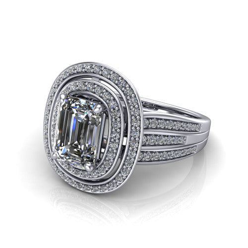 Stephanie emerald double halo engagement ring in Platinum, three-quarter perspective showing the emerald center in a double pav&eacute; halo above a pav&eacute; split shank