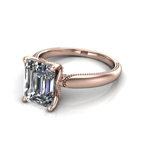 Laila emerald solitaire engagement ring in 14K Rose Gold, three-quarter perspective showing the double-prong center raised above a milgrain-edged polished band