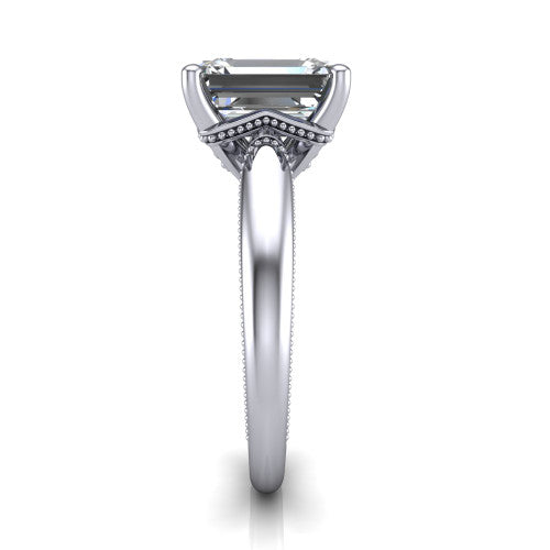 Laila emerald solitaire engagement ring in 18K White Gold, side profile showing the milgrain detailing running down the polished band in profile