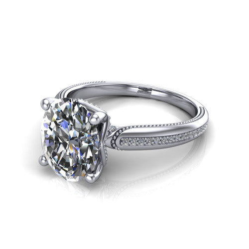 Vanessa oval solitaire engagement ring in Platinum, three-quarter perspective showing the prong-set center raised above a slim pav&eacute; milgrain band