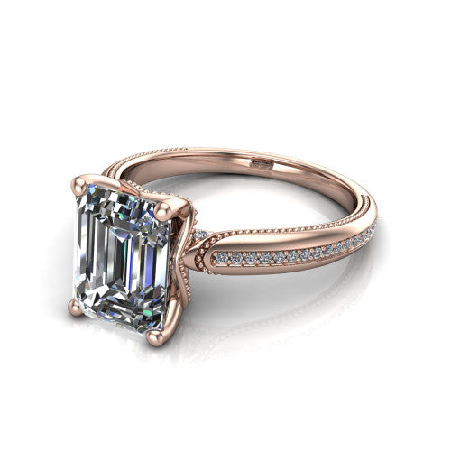 Vanessa emerald solitaire engagement ring in 18K Rose Gold, three-quarter perspective showing the prong-set center raised above a slim pav&eacute; milgrain band