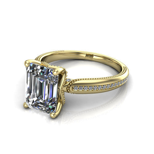 Vanessa emerald solitaire engagement ring in 14K Yellow Gold, three-quarter perspective showing the prong-set center raised above a slim pav&eacute; milgrain band