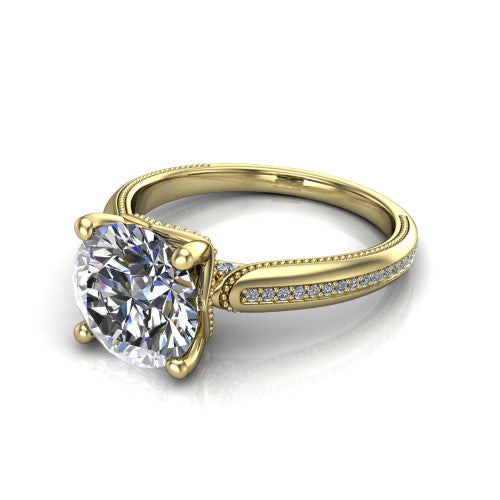 Vanessa round solitaire engagement ring in 18K Yellow Gold, three-quarter perspective showing the prong-set center raised above a slim pav&eacute; milgrain band