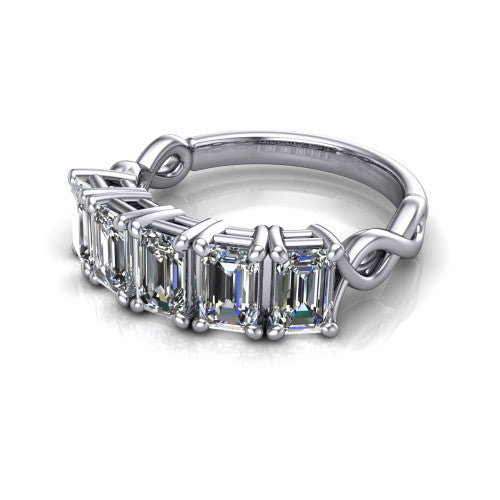 Aitana emerald three stone engagement ring in 18K White Gold, three-quarter perspective showing the round center between two round side stones in bar settings on a plain polished band