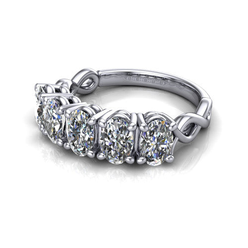 Aitana oval three stone engagement ring in 18K White Gold, three-quarter perspective showing the round center between two round side stones in bar settings on a plain polished band