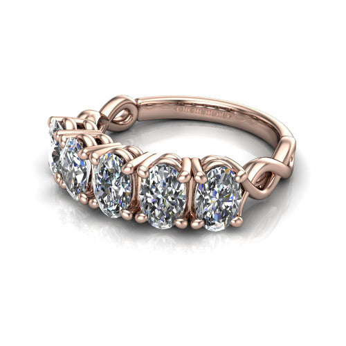 Aitana oval three stone engagement ring in 14K Rose Gold, three-quarter perspective showing the round center between two round side stones in bar settings on a plain polished band