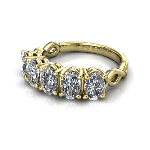 Aitana oval three stone engagement ring in 14K Yellow Gold, three-quarter perspective showing the round center between two round side stones in bar settings on a plain polished band