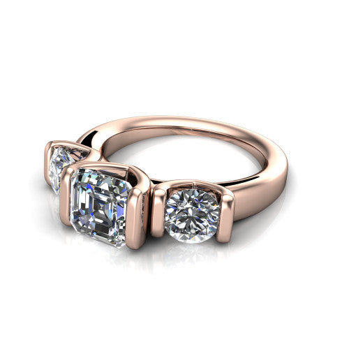 Elianna square emerald three stone engagement ring in 14K Rose Gold, three-quarter perspective showing the round center between two round side stones in bar settings on a plain polished band