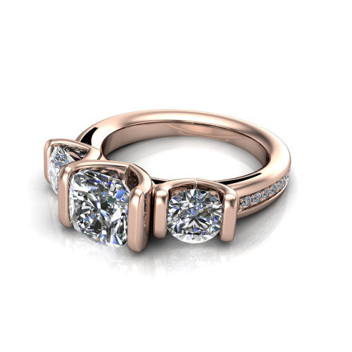 Fatima cushion three stone engagement ring in 14K Rose Gold, three-quarter perspective showing the round center between two round side stones in bar settings above a pav&eacute; band