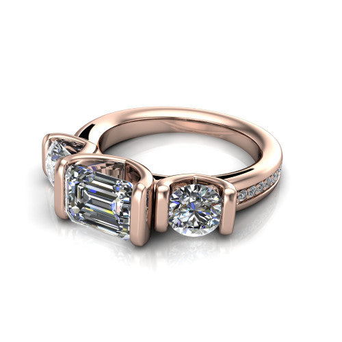 Fatima emerald three stone engagement ring in 18K Rose Gold, three-quarter perspective showing the round center between two round side stones in bar settings above a pav&eacute; band