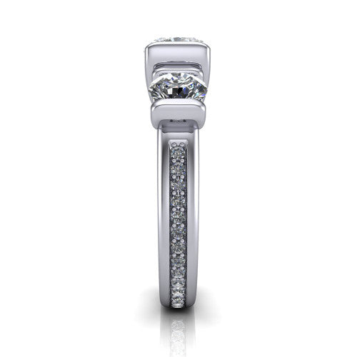 Fatima cushion three stone engagement ring in Platinum, side profile showing the pav&eacute; running down the band and the bar-set side stones in profile