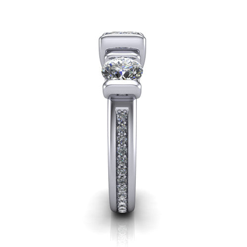 Fatima emerald three stone engagement ring in 14K White Gold, side profile showing the pav&eacute; running down the band and the bar-set side stones in profile