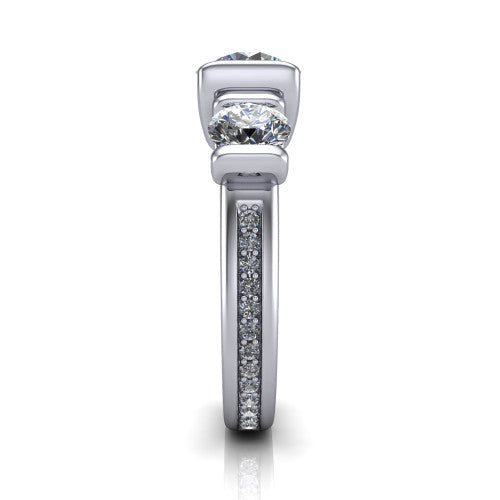 Fatima round three stone engagement ring in Platinum, side profile showing the pav&eacute; running down the band and the bar-set side stones in profile
