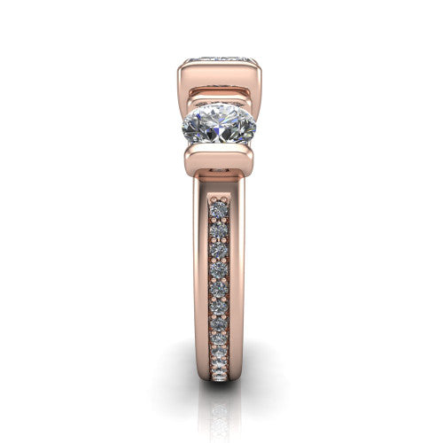 Fatima emerald three stone engagement ring in 14K Rose Gold, side profile showing the pav&eacute; running down the band and the bar-set side stones in profile