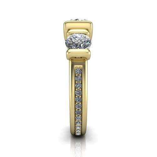 Fatima oval three stone engagement ring in 14K Yellow Gold, side profile showing the pav&eacute; running down the band and the bar-set side stones in profile
