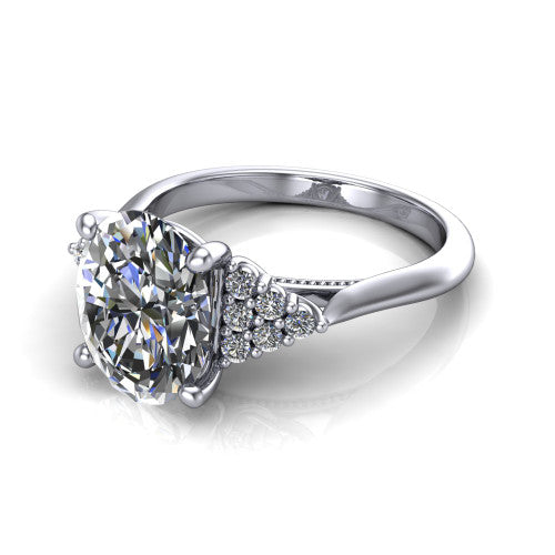 Raya oval three stone engagement ring in Platinum, three-quarter perspective showing the center stone flanked by a trio diamond cluster on each shoulder above a slim milgrain band