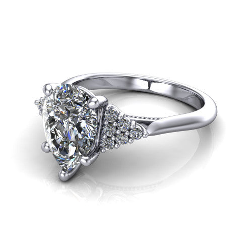 Raya pear three stone engagement ring in Platinum, three-quarter perspective showing the center stone flanked by a trio diamond cluster on each shoulder above a slim milgrain band
