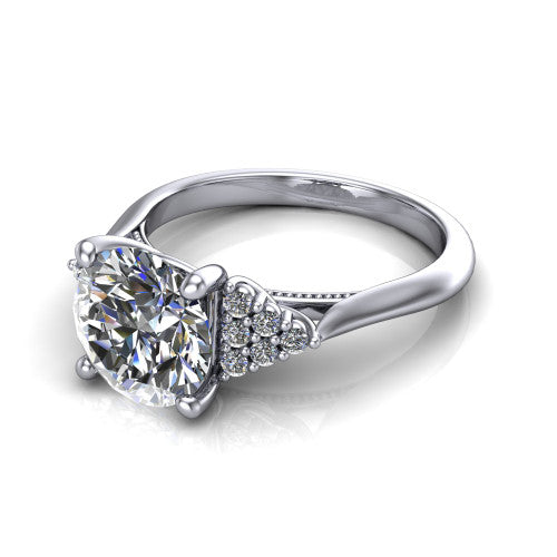 Raya round three stone engagement ring in 14K White Gold, three-quarter perspective showing the center stone flanked by a trio diamond cluster on each shoulder above a slim milgrain band