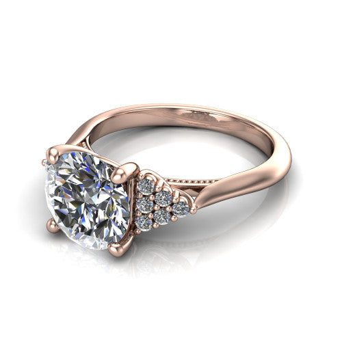 Raya round three stone engagement ring in 18K Rose Gold, three-quarter perspective showing the center stone flanked by a trio diamond cluster on each shoulder above a slim milgrain band
