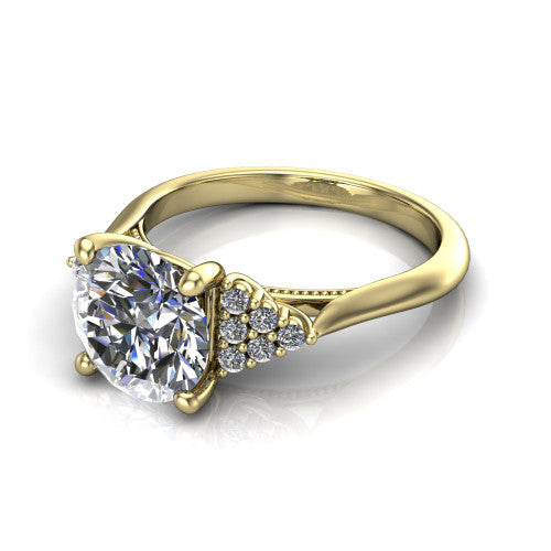 Raya round three stone engagement ring in 18K Yellow Gold, three-quarter perspective showing the center stone flanked by a trio diamond cluster on each shoulder above a slim milgrain band