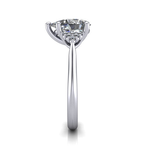 Raya pear three stone engagement ring in Platinum, side profile showing the slim milgrain cathedral band and the side clusters in profile