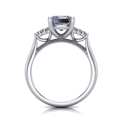 Raya emerald three stone engagement ring in 18K White Gold, through-finger front profile showing the four-prong center raised above the cathedral band with cluster shoulders