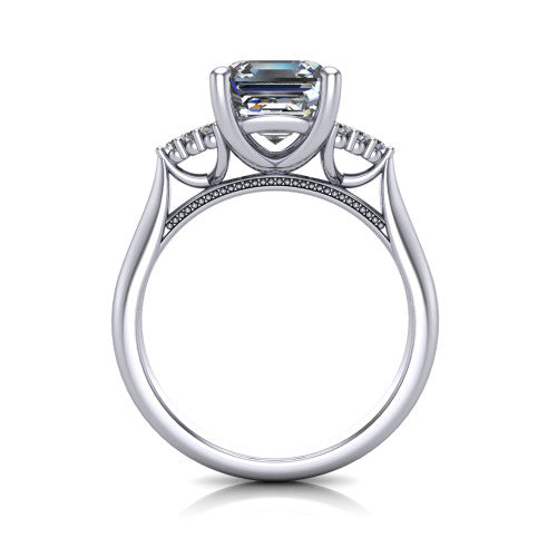 Raya square emerald three stone engagement ring in 18K White Gold, through-finger front profile showing the four-prong center raised above the cathedral band with cluster shoulders