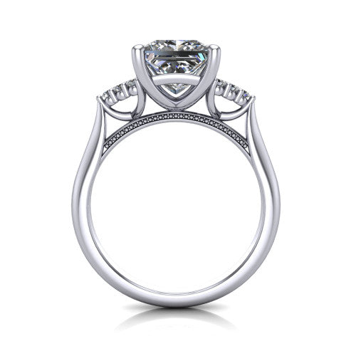 Raya princess three stone engagement ring in Platinum, through-finger front profile showing the four-prong center raised above the cathedral band with cluster shoulders