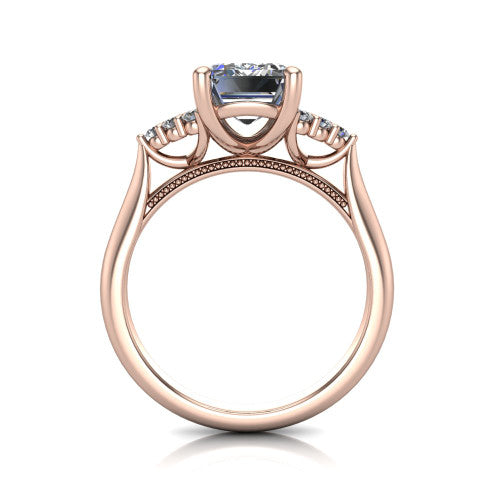 Raya emerald three stone engagement ring in 14K Rose Gold, through-finger front profile showing the four-prong center raised above the cathedral band with cluster shoulders