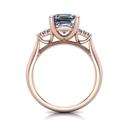 Raya square emerald three stone engagement ring in 14K Rose Gold, through-finger front profile showing the four-prong center raised above the cathedral band with cluster shoulders