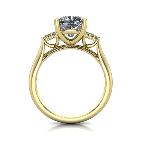 Raya cushion three stone engagement ring in 14K Yellow Gold, through-finger front profile showing the four-prong center raised above the cathedral band with cluster shoulders