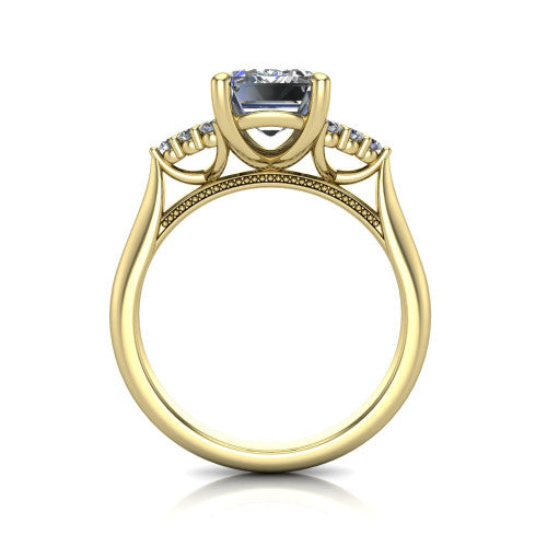 Raya emerald three stone engagement ring in 14K Yellow Gold, through-finger front profile showing the four-prong center raised above the cathedral band with cluster shoulders