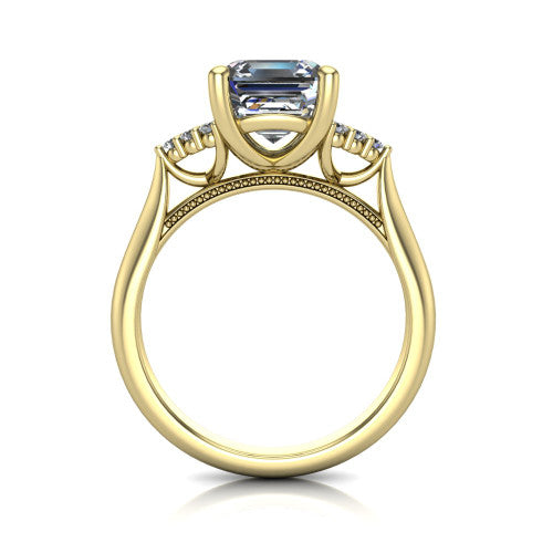 Raya square emerald three stone engagement ring in 14K Yellow Gold, through-finger front profile showing the four-prong center raised above the cathedral band with cluster shoulders