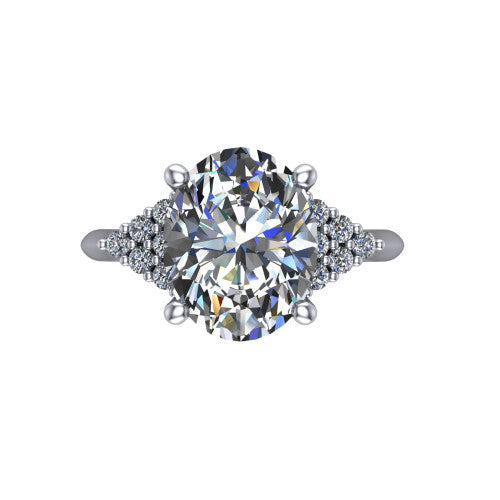 Raya oval three stone engagement ring in 18K White Gold, top-down view showing the round center with graduated three-stone clusters to each side from above