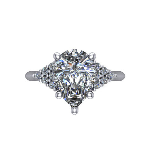 Raya pear three stone engagement ring in 14K White Gold, top-down view showing the round center with graduated three-stone clusters to each side from above