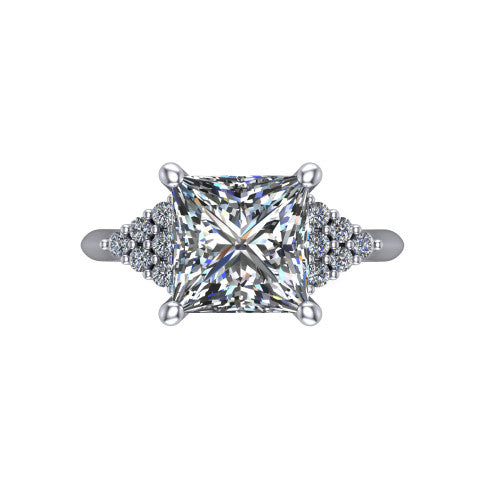 Raya princess three stone engagement ring in Platinum, top-down view showing the round center with graduated three-stone clusters to each side from above