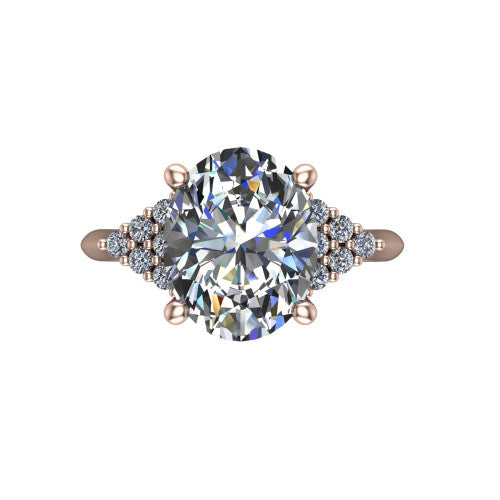 Raya oval three stone engagement ring in 18K Rose Gold, top-down view showing the round center with graduated three-stone clusters to each side from above