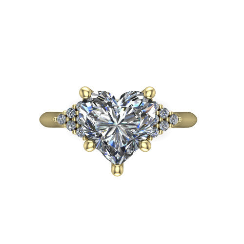 Raya heart three stone engagement ring in 14K Yellow Gold, top-down view showing the round center with graduated three-stone clusters to each side from above