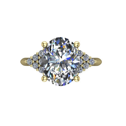 Raya oval three stone engagement ring in 18K Yellow Gold, top-down view showing the round center with graduated three-stone clusters to each side from above