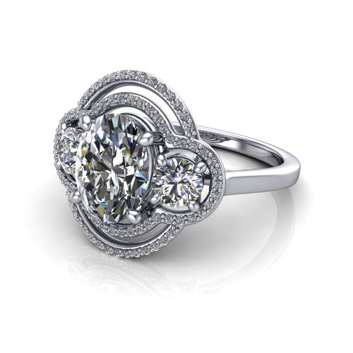 Elle oval three stone halo engagement ring in Platinum, three-quarter perspective showing the center stone flanked by two side stones in an interlocking double pav&eacute; halo above a tapered band