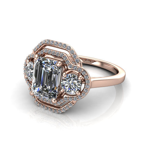 Elle emerald three stone halo engagement ring in 14K Rose Gold, three-quarter perspective showing the center stone flanked by two side stones in an interlocking double pav&eacute; halo above a tapered band