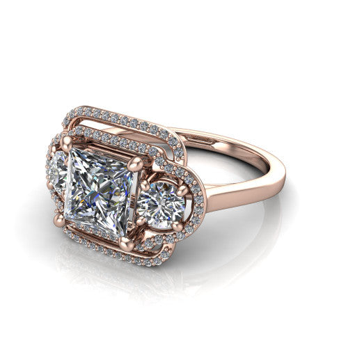Elle princess three stone halo engagement ring in 18K Rose Gold, three-quarter perspective showing the center stone flanked by two side stones in an interlocking double pav&eacute; halo above a tapered band
