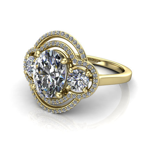 Elle oval three stone halo engagement ring in 18K Yellow Gold, three-quarter perspective showing the center stone flanked by two side stones in an interlocking double pav&eacute; halo above a tapered band
