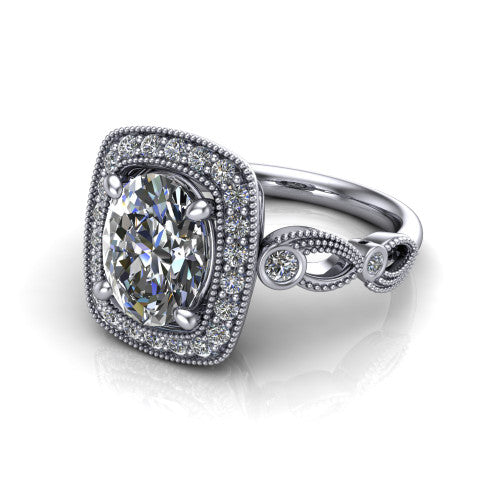 Lana oval halo engagement ring in Platinum, three-quarter perspective showing the center in a milgrain cushion halo above a vintage leaf-motif band