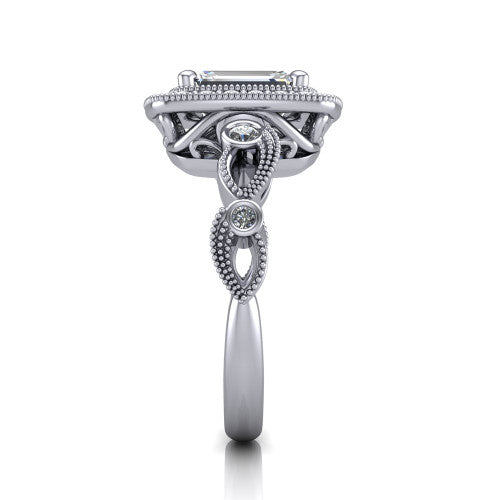 Lana emerald halo engagement ring in Platinum, side profile showing the open filigree undergallery and the bezel-set accent on the vintage leaf band