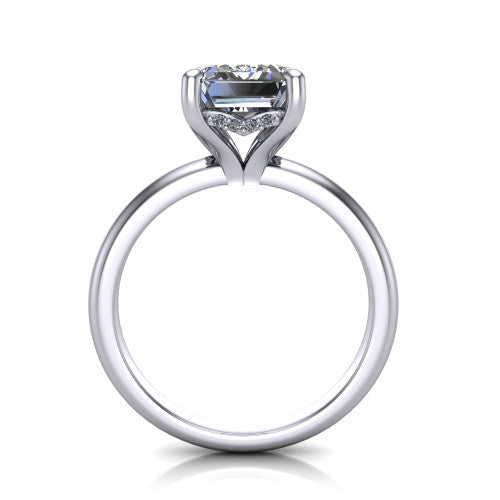 Ariel emerald classic engagement ring in Platinum, through-finger front profile showing the hidden halo of accent diamonds tucked beneath the center basket