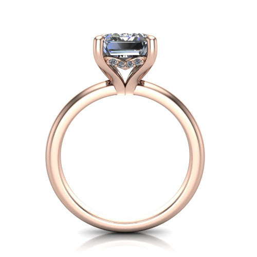 Ariel emerald classic engagement ring in 14K Rose Gold, through-finger front profile showing the hidden halo of accent diamonds tucked beneath the center basket