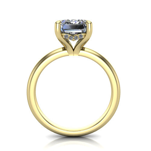 Ariel emerald classic engagement ring in 14K Yellow Gold, through-finger front profile showing the hidden halo of accent diamonds tucked beneath the center basket